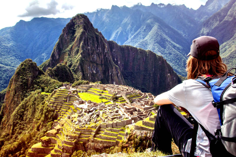 Tourist observing the Inca citadel of Machu Picchu