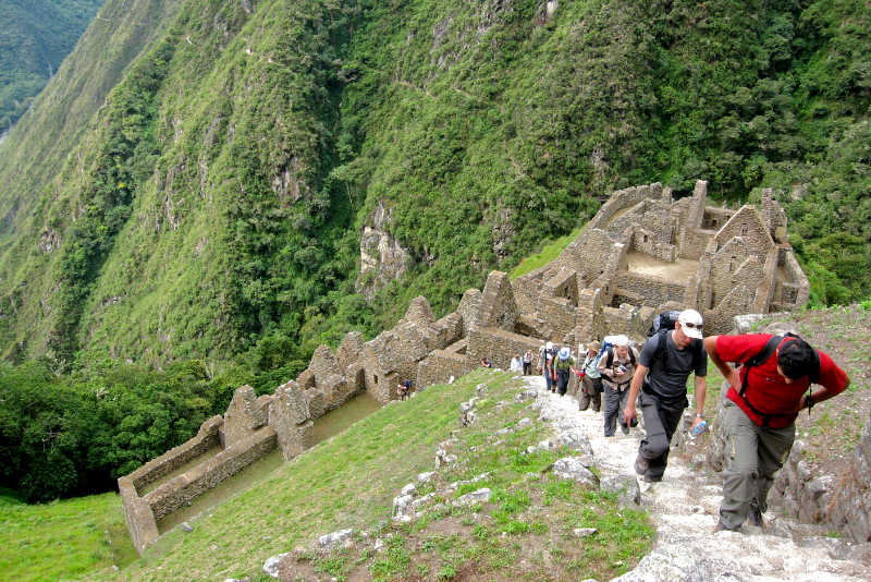 Tourists climbing the stone stairs